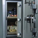 A close up of an open safe with some items inside