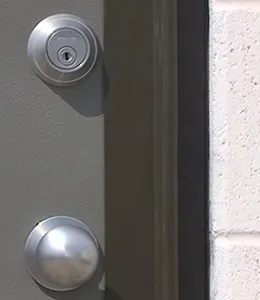 A door with two locks and one key hole.